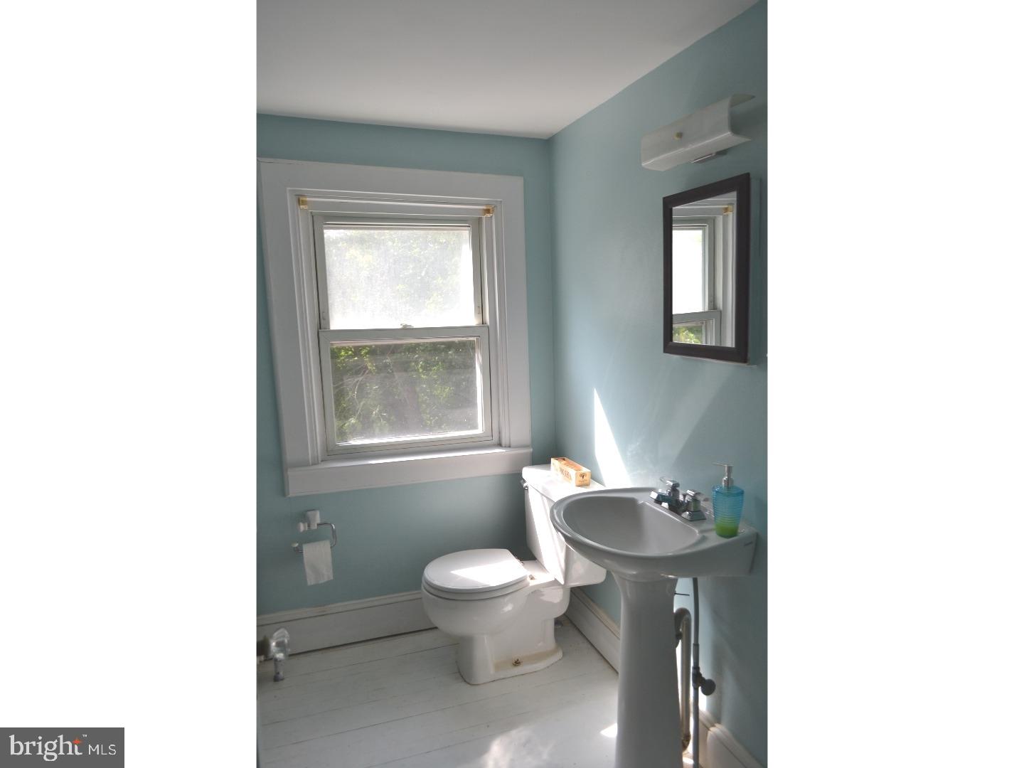 129 Walsh Road Lansdowne, PA 19050 - Photo 21 of 25 a bathroom with a toilet a sink and a mirror
