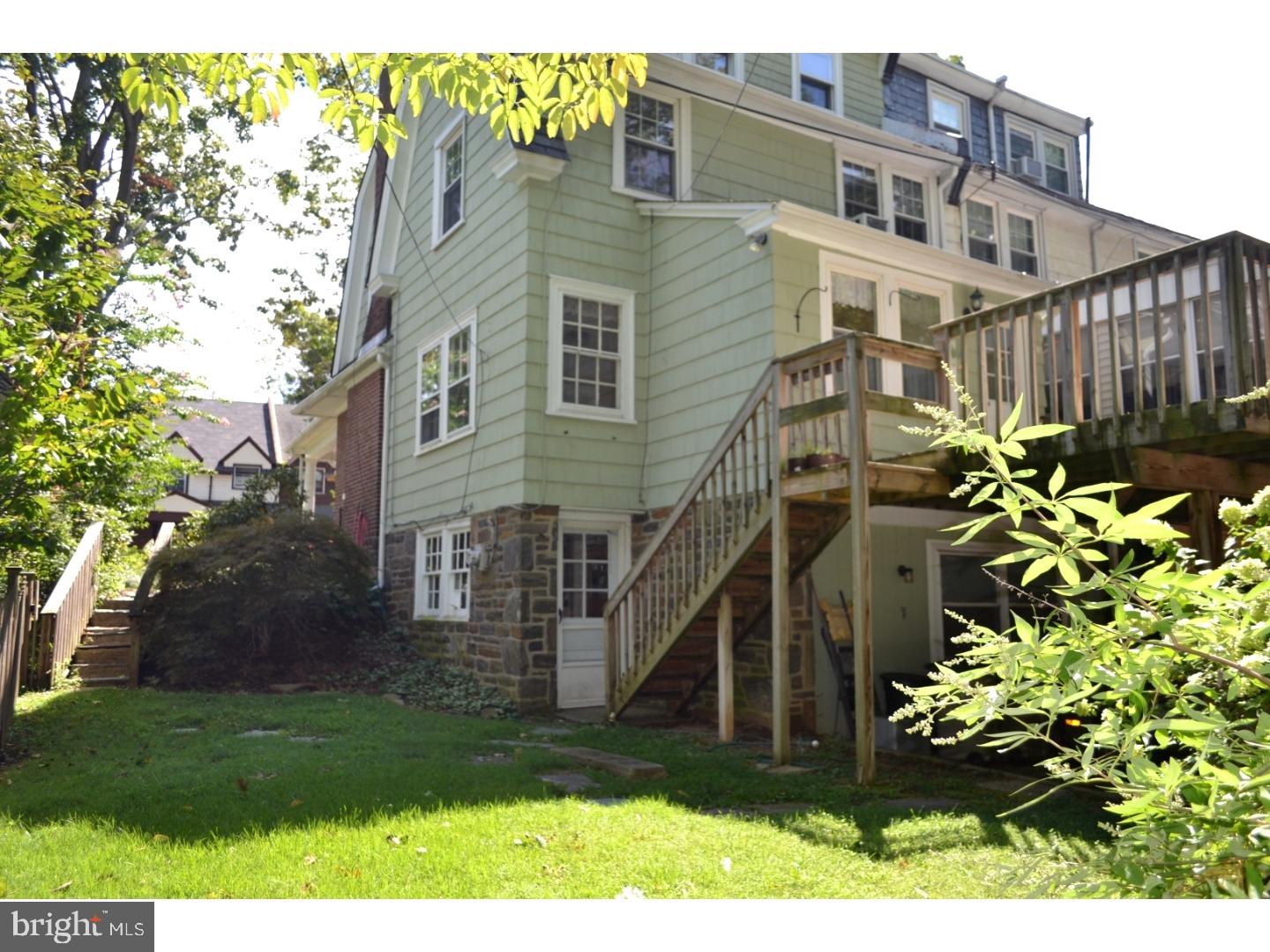 129 Walsh Road Lansdowne, PA 19050 - Photo 24 of 25 a view of a house with brick walls and a flower plants