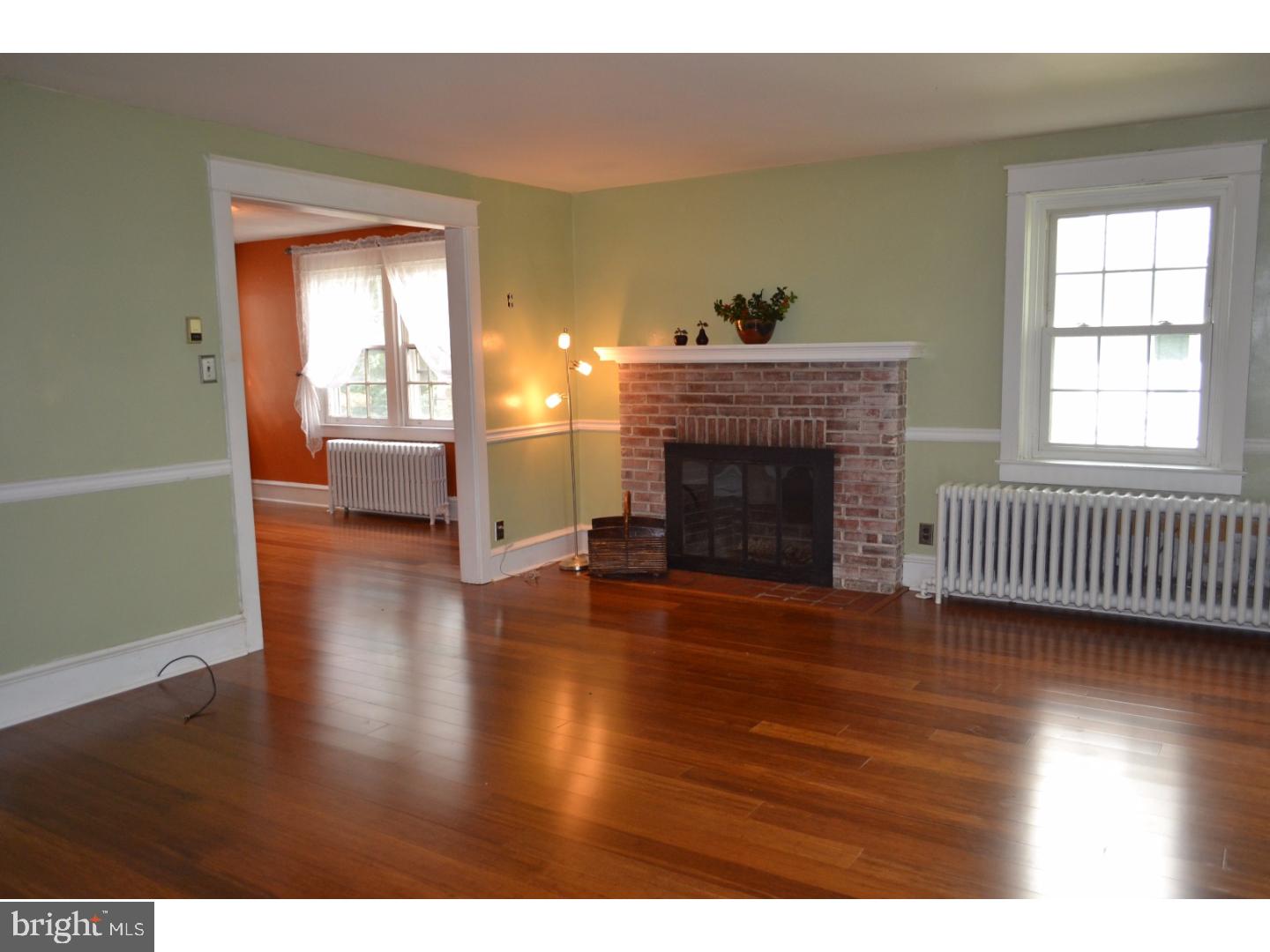 129 Walsh Road Lansdowne, PA 19050 - Photo 4 of 25 a view of empty room with wooden floor and fireplace