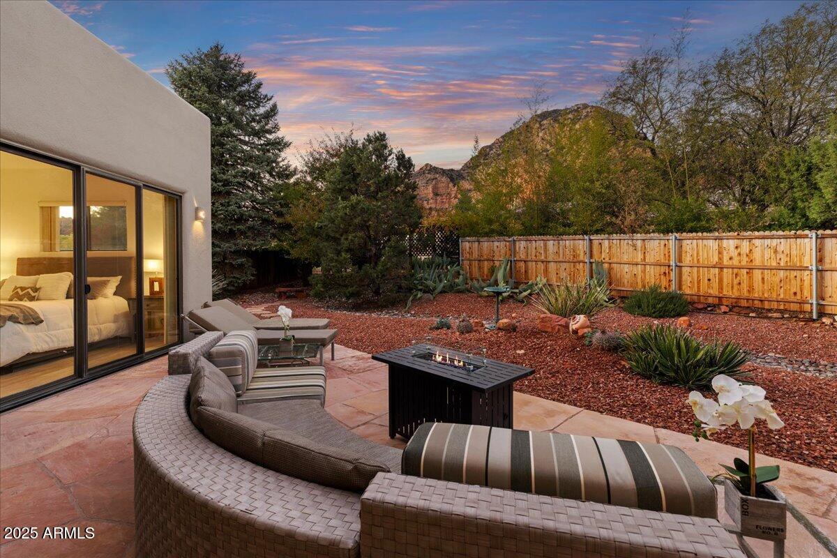 50 Ranch Road Sedona, AZ 86336 - Photo 22 of 51 a view of a patio with couches chairs dining table and chairs with wooden floor