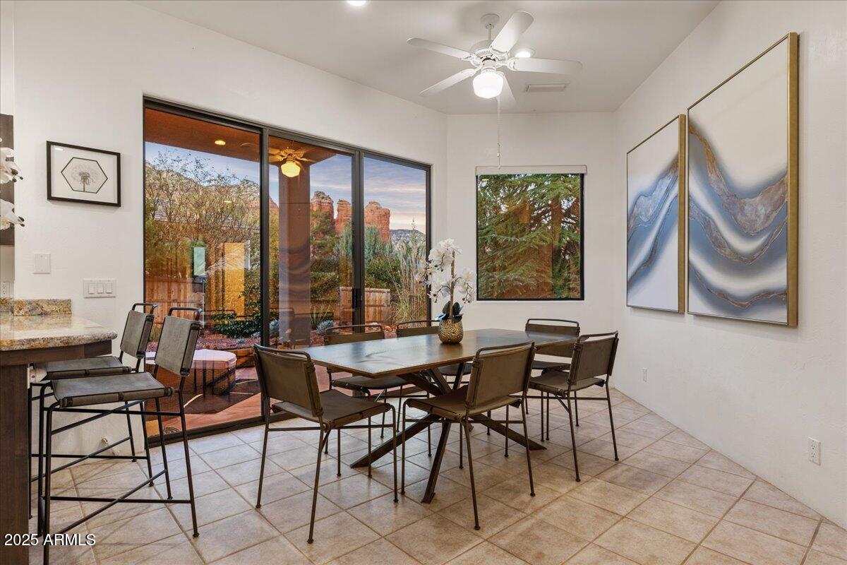50 Ranch Road Sedona, AZ 86336 - Photo 34 of 51 a dining room with furniture a flat screen tv and a large window