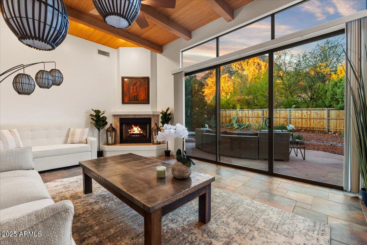50 Ranch Road Sedona, AZ 86336 - Photo 41 of 51 a living room with furniture a fireplace and a floor to ceiling window