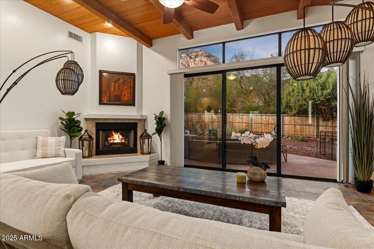 50 Ranch Road Sedona, AZ 86336 - Photo 43 of 51 a living room with furniture a large window and a fireplace