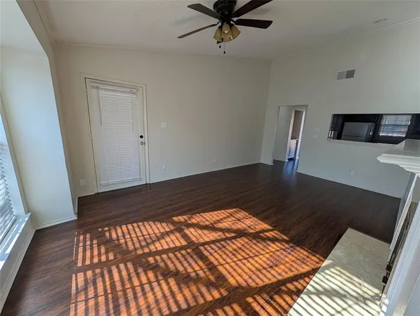 a view of a room with wooden floor and staircase