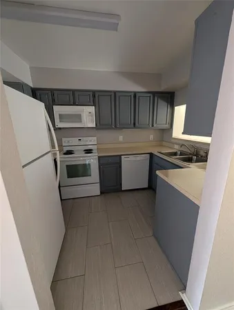 a kitchen with stainless steel appliances granite countertop a stove a refrigerator and a sink