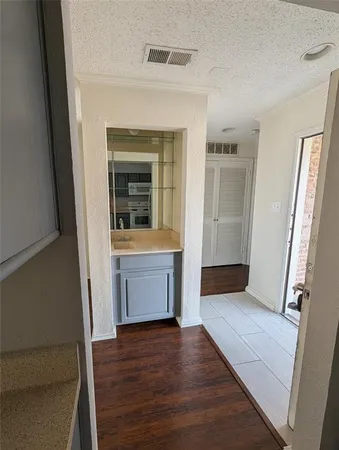 a view of front door and hallway with wooden floor