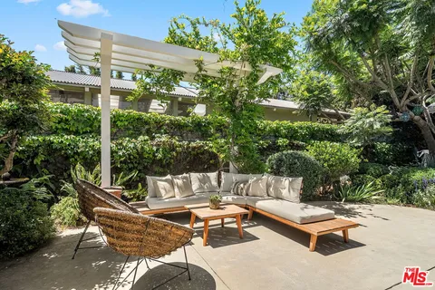 a view of a chairs and table in the patio