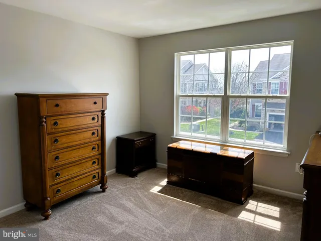 a room with a dresser and a window