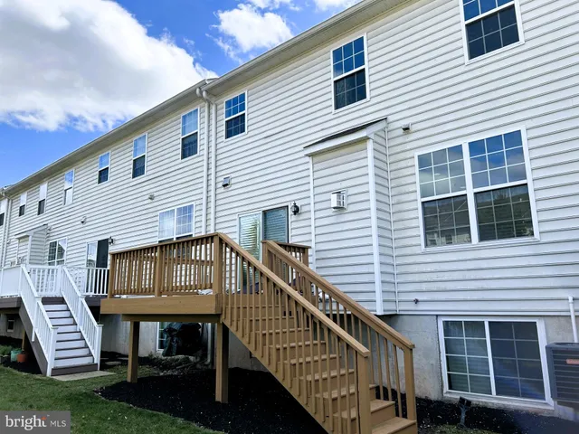 a view of house with a deck and furniture