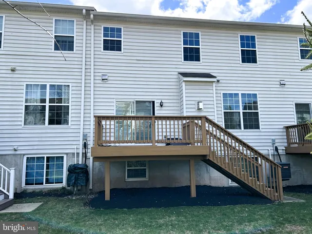 a view of a house with a small deck and a large window
