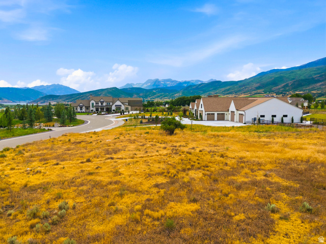 574 South Fox Den Road, Unit 3 Midway, UT 84049 - Photo 32 of 45 Expansive lot featuring mature natural vegetation, a paved road, and distant mountain scenery