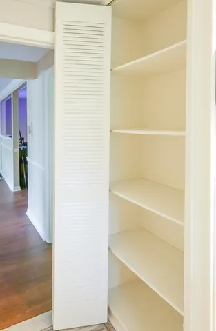 a view of walk in closet with empty racks
