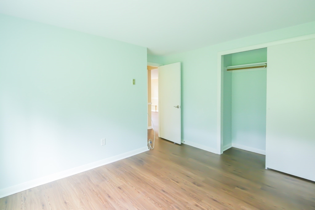74 Beach Street, Unit 12 Woburn, MA 01801 - Photo 13 of 14 a view of an empty room with wooden floor