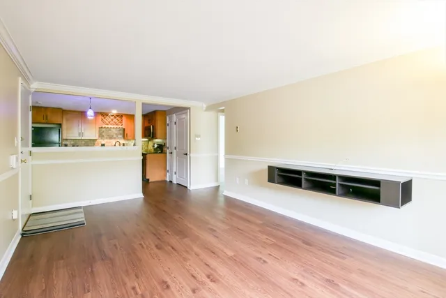 a view of a kitchen with wooden floor and a sink