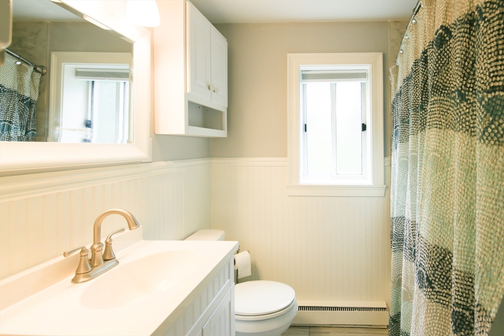 74 Beach Street, Unit 12 Woburn, MA 01801 - Photo 10 of 14 a bathroom with a sink a toilet and shower