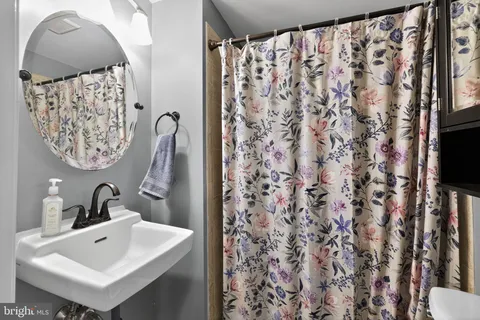 a bathroom with a sink and mirror with toilet