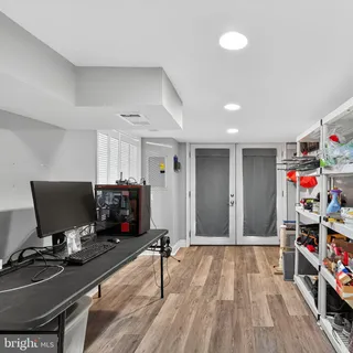 a view of a workspace with furniture and wooden floor