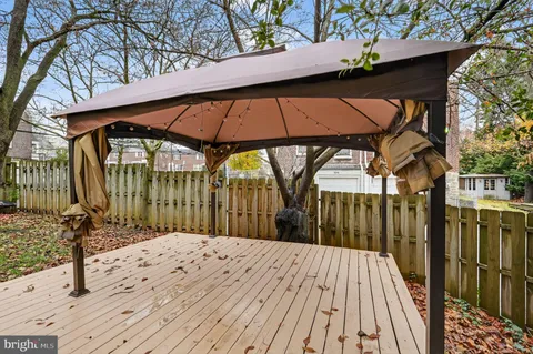 a view of a wooden deck with a backyard