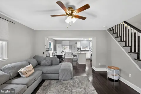 a living room with furniture and view of kitchen