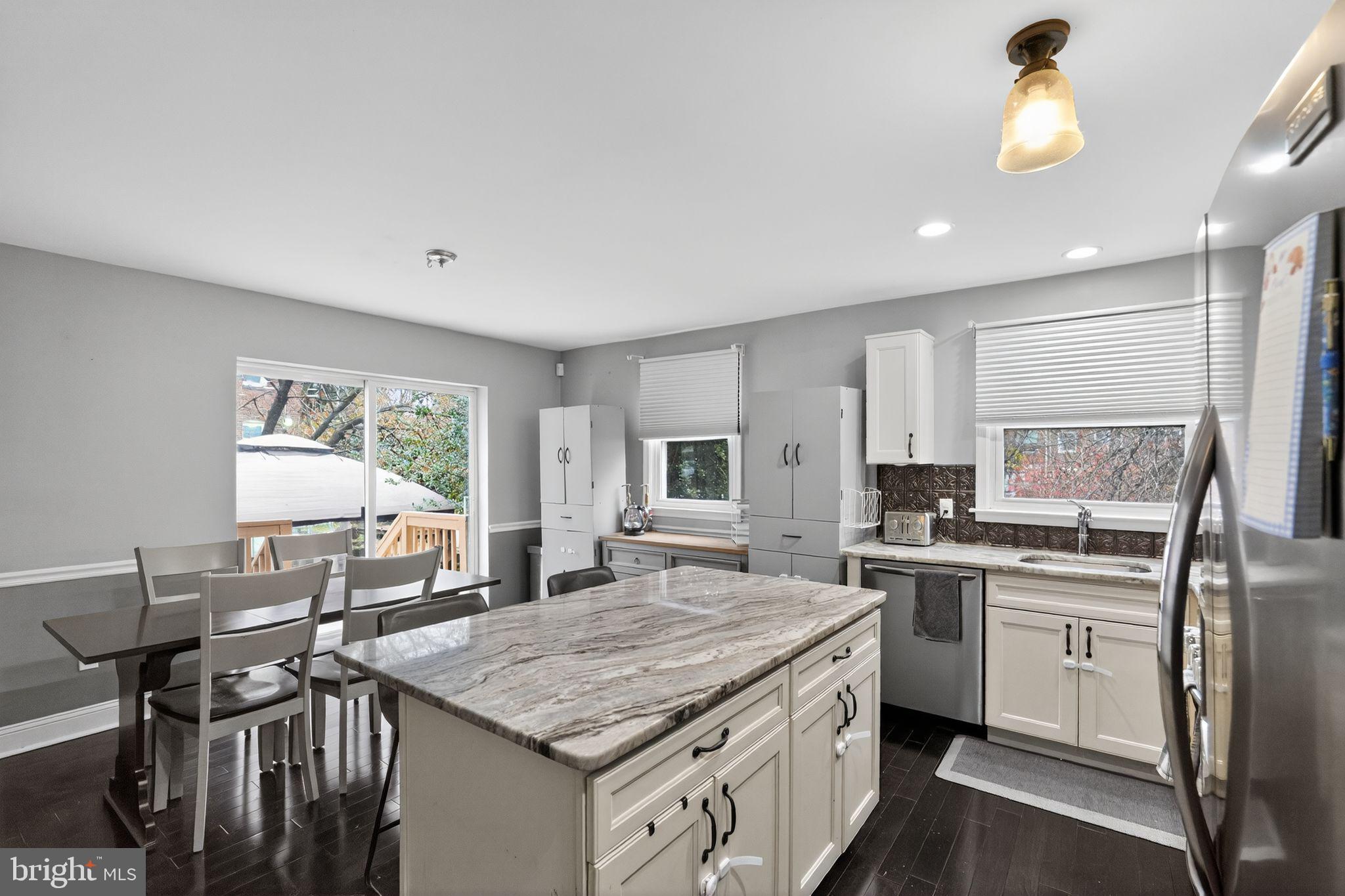 289 Cheswold Road Drexel Hill, PA 19026 - Photo 10 of 29 a kitchen with a stove a sink a dining table and chairs