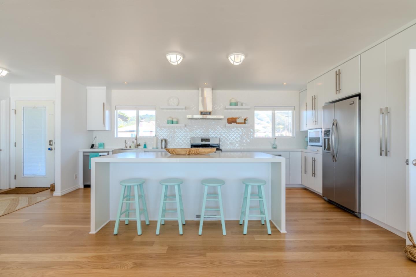 236 Shoreview Avenue Pacifica, CA 94044 - Photo 12 of 61 a kitchen with stainless steel appliances granite countertop a dining table chairs refrigerator and cabinets