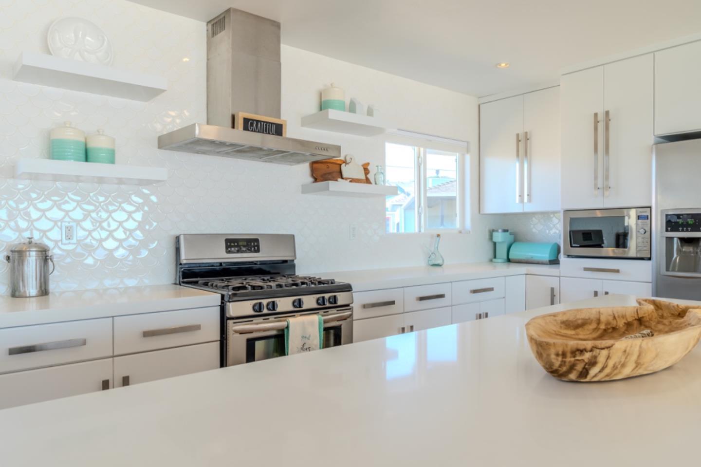 236 Shoreview Avenue Pacifica, CA 94044 - Photo 17 of 61 a kitchen with stainless steel appliances a stove a sink and a microwave