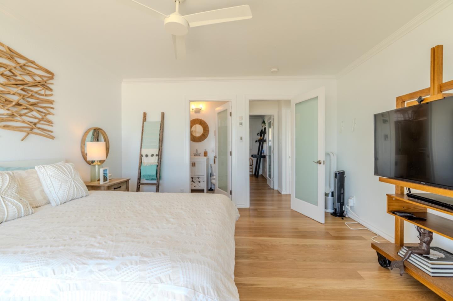 236 Shoreview Avenue Pacifica, CA 94044 - Photo 34 of 61 a bedroom with a bed and a flat tv screen on wall