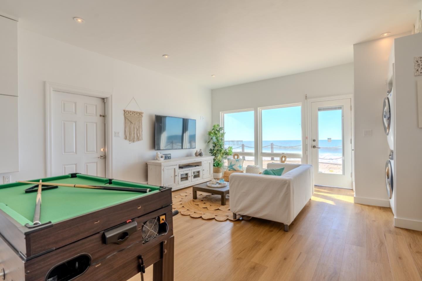 236 Shoreview Avenue Pacifica, CA 94044 - Photo 45 of 61 a living room with a couch a large window and a dining table