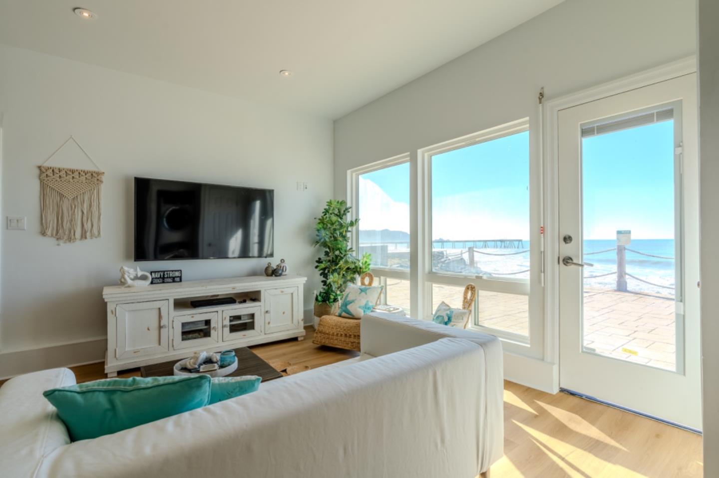 236 Shoreview Avenue Pacifica, CA 94044 - Photo 53 of 61 a living room with furniture a flat screen tv and a floor to ceiling window