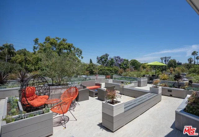 a view of a terrace with couches and potted plants