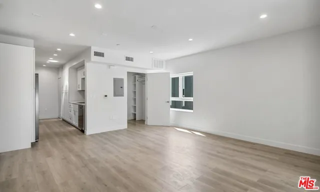 a view of a livingroom with wooden floor and windows