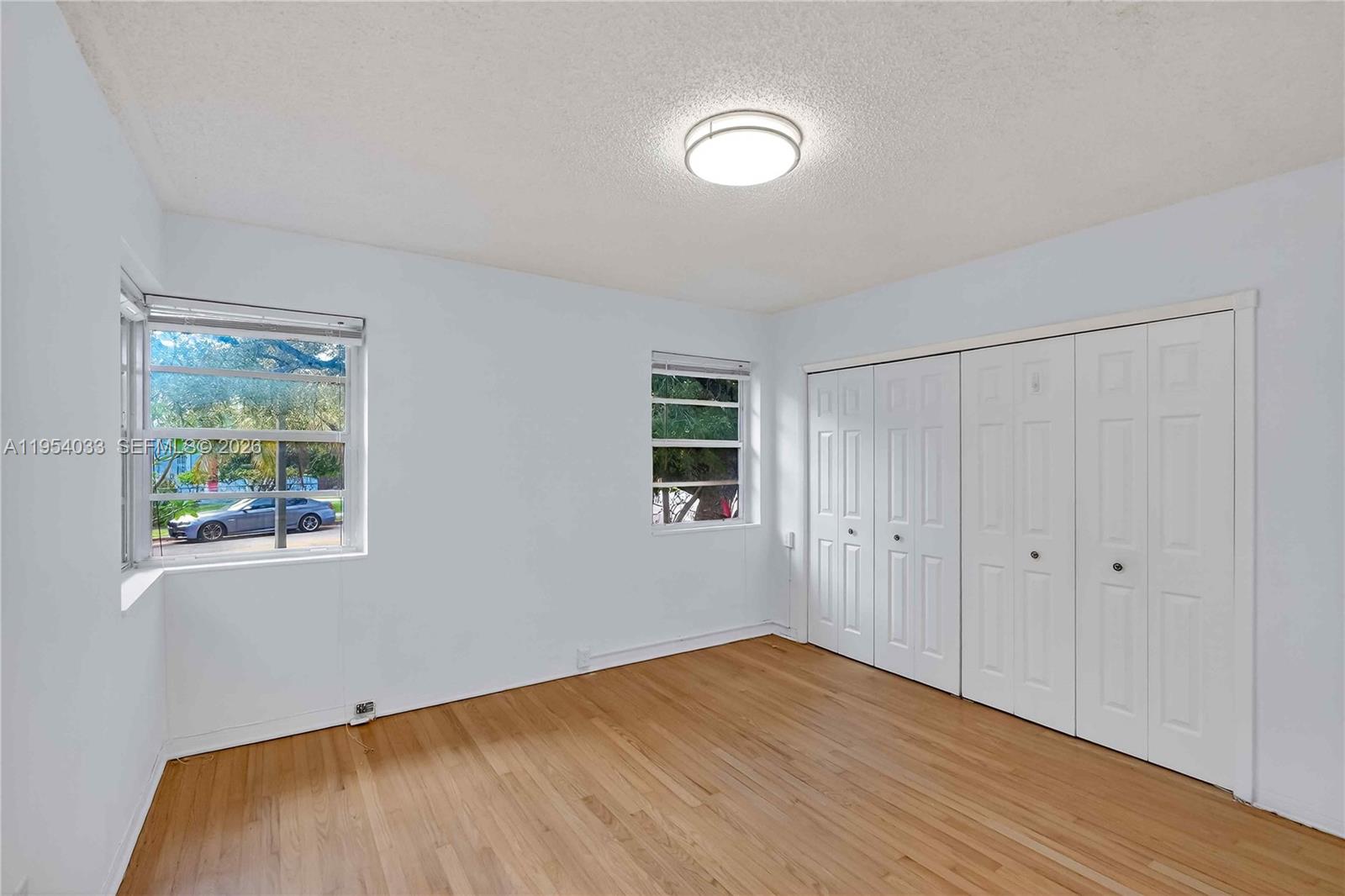 2399 Southwest 26th Lane Miami, FL 33133 - Photo 21 of 39 a view of empty room with wooden floor and fan