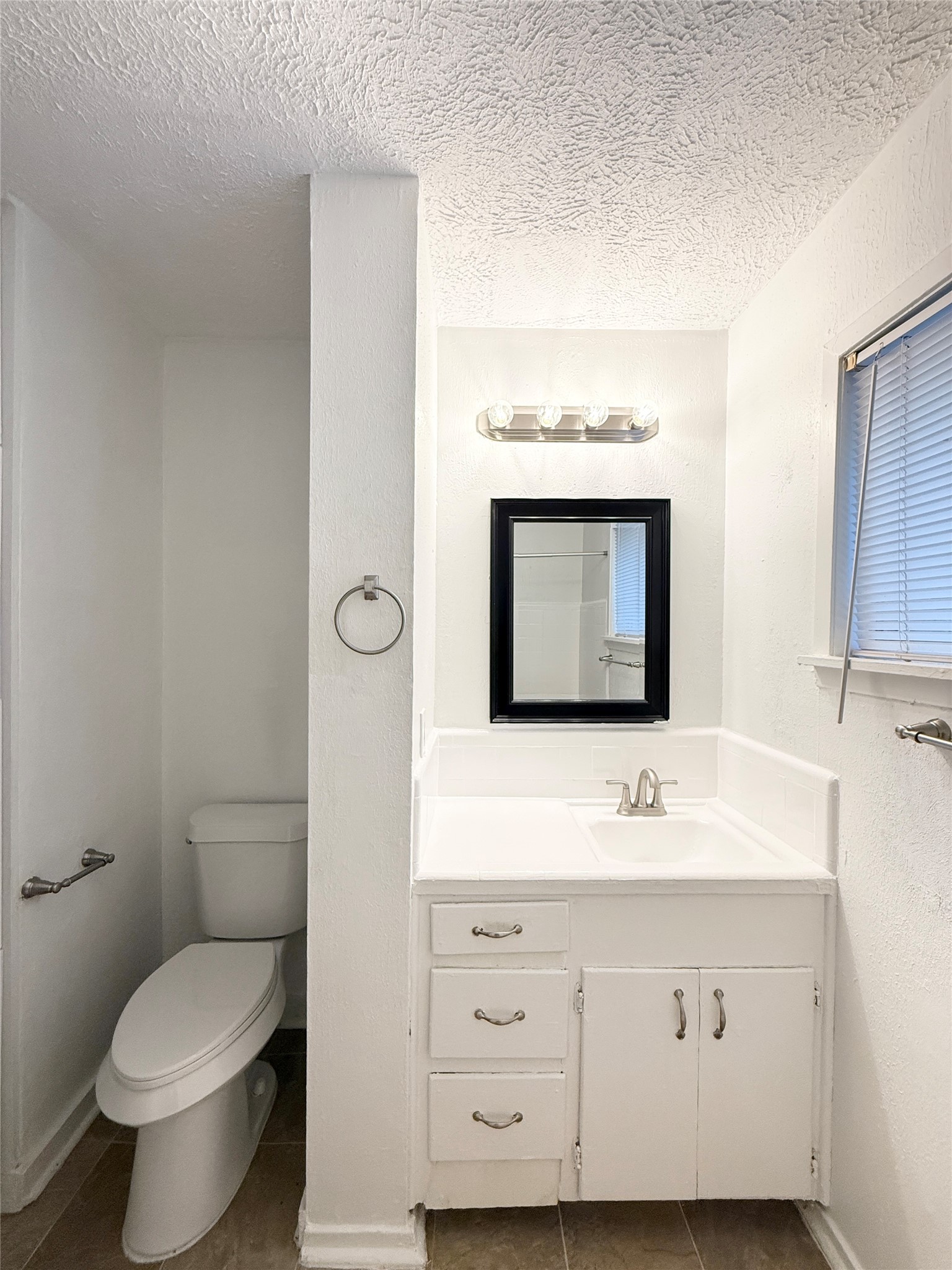 3629 North MacGregor Way, Unit 3 Houston, TX 77004 - Photo 14 of 14 a bathroom with a toilet sink and mirror