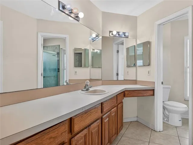 a bathroom with a sink a toilet and mirror