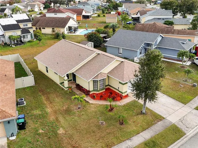 an aerial view of residential houses with outdoor space