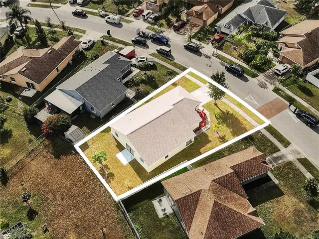 an aerial view of a tennis ground with a lawn chairs