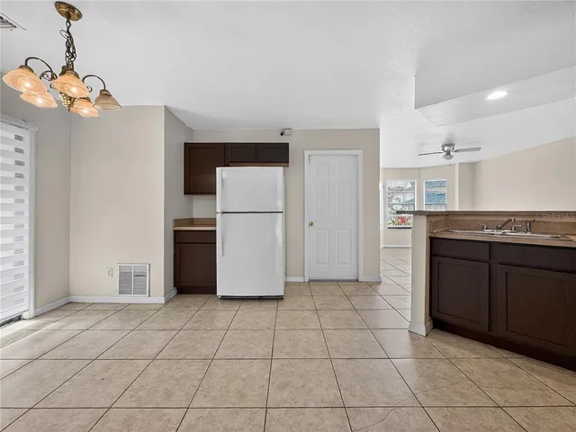 a kitchen with a refrigerator a microwave and a sink