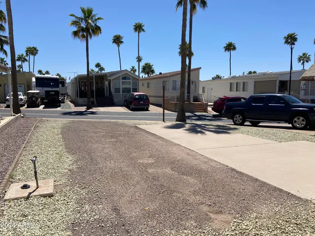 a view of a lake with a car parked in the road