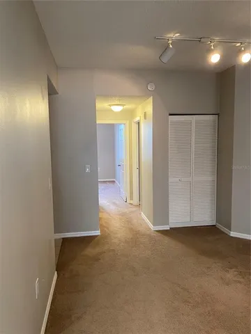an empty room with closet and wooden floor
