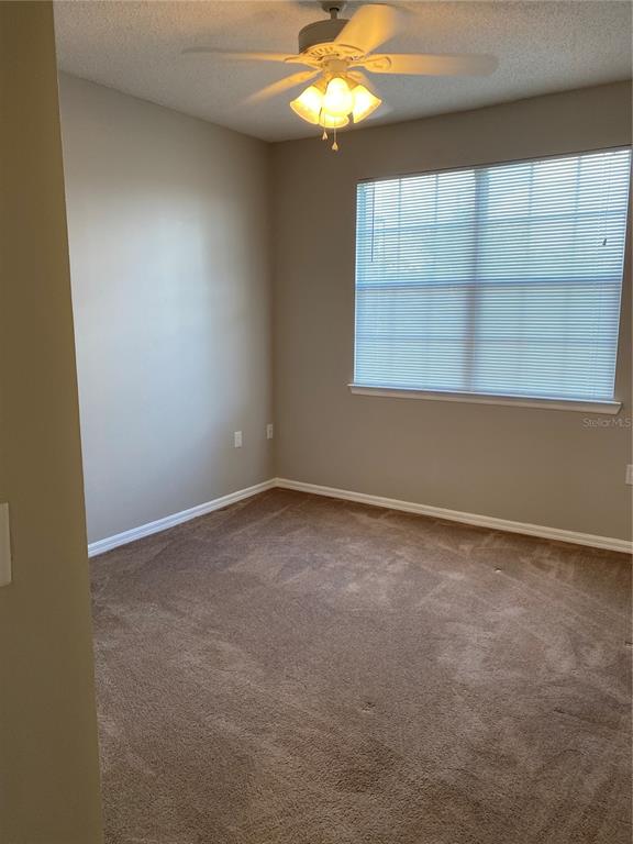 10825 Windsor Walk Drive, Unit 3201 Orlando, FL 32837 - Photo 6 of 10 an empty room with a window