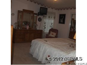 746 Navigators Way Edgewater, FL 32141 - Photo 13 of 14 a bedroom with a bed and a television