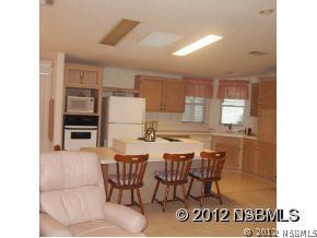 746 Navigators Way Edgewater, FL 32141 - Photo 7 of 14 a kitchen with a table and chairs