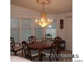 746 Navigators Way Edgewater, FL 32141 - Photo 9 of 14 a view of a dining room with furniture and chandelier