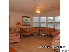 746 Navigators Way Edgewater, FL 32141 - Photo 10 of 14 a living room with furniture and a chandelier