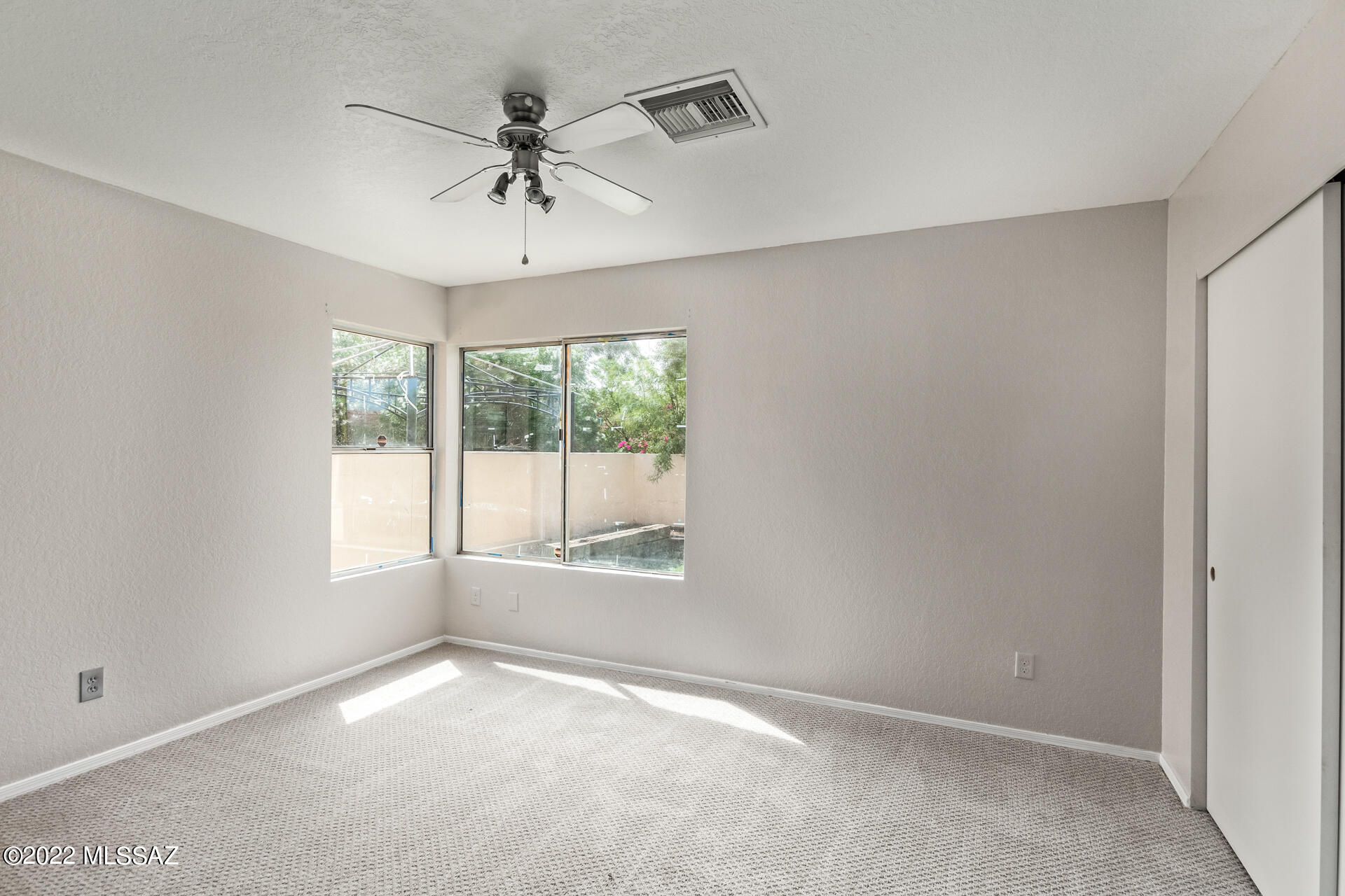 4697 West Weathervane Street Tucson, AZ 85741 - Photo 14 of 25 an empty room with a window and a fan