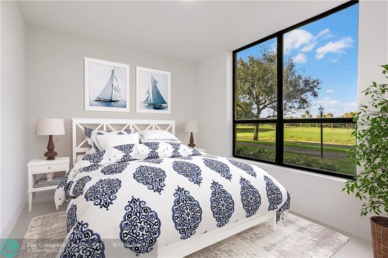 7145 Promenade Drive, Unit 101C Boca Raton, FL 33433 - Photo 12 of 23 a bedroom with a large bed and a window