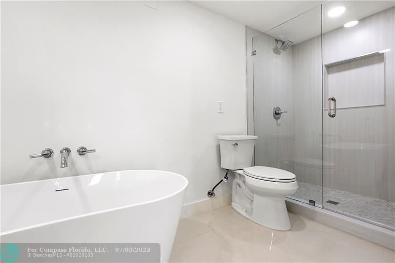 7145 Promenade Drive, Unit 101C Boca Raton, FL 33433 - Photo 18 of 23 a white toilet sitting next to a bathroom sink