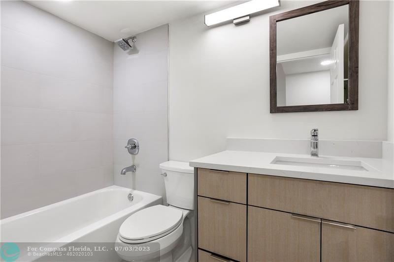 7145 Promenade Drive, Unit 101C Boca Raton, FL 33433 - Photo 19 of 23 a bathroom with a sink toilet vanity and tub
