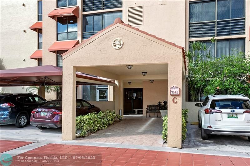 7145 Promenade Drive, Unit 101C Boca Raton, FL 33433 - Photo 21 of 23 a view of a car park in front of building
