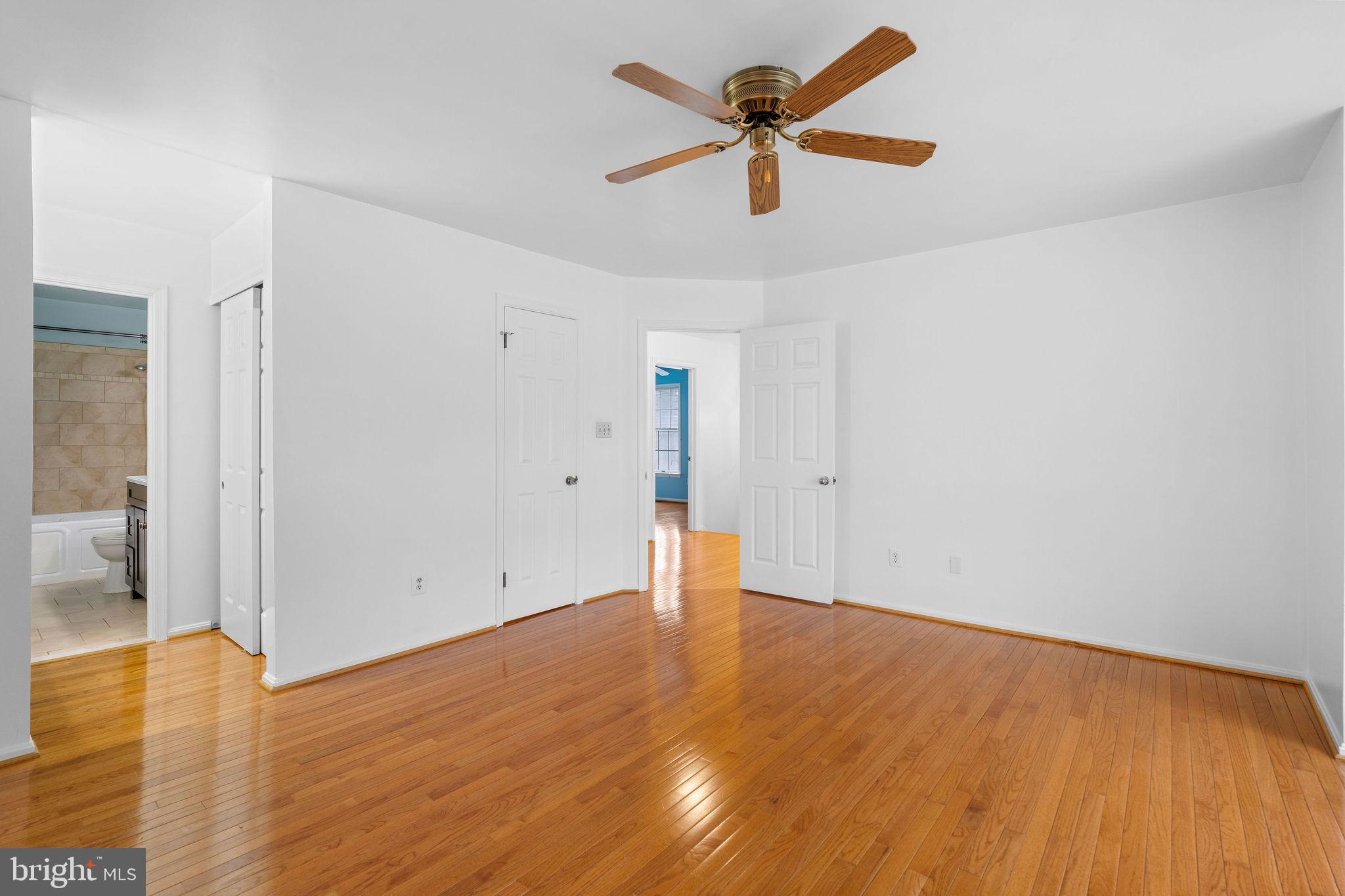 9301 Bellbeck Road Baltimore, MD 21234 - Photo 16 of 35 an empty room with wooden floor and a ceiling fan